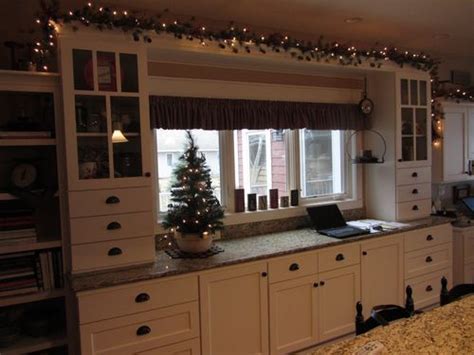 The christmas wreath is an essential part of any christmas decorating plan. Garland with lights above cabinets | Home decor furniture ...