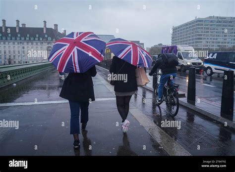 London Uk 8 November 2023 Pedestrians On Westminster Bridge Are Caught In Heavy Rain Showers