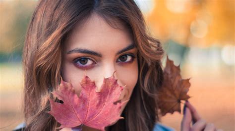 girl model with autumn leaf standing in colorful blur bokeh background hd girls wallpapers hd