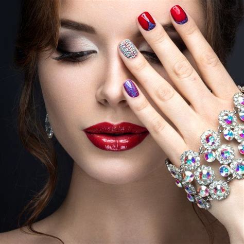 Beautiful Girl With A Bright Evening Make Up And Red Manicure With