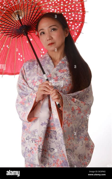 Japanese Lady Wearing A Pink And Lilac Patterned Kimono And Holding A