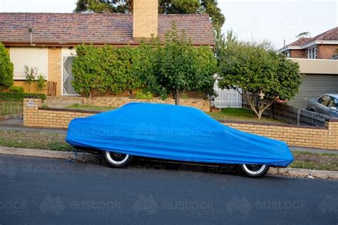 Image Of A Car Parked On The Street Under A Blue Cover Austockphoto