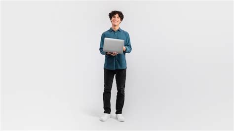 Premium Photo Guy Holding Laptop Surfing Web On Light Gray Background