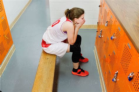 Female Basketball Player Sits In Locker Room By Stocksy Contributor