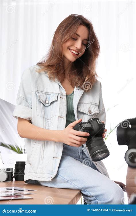 Professional Photographer With Camera Working In Office Stock Photo