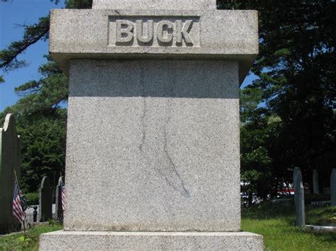 A Stone Monument With The Word Buck On It And An American Flag In The