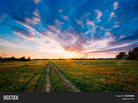 Sunset Sunrise Over Rural Meadow Field Bright Dramatic