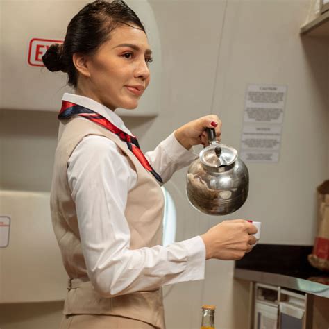 female flight attendant prepares coffee for the passengers on board travel off path