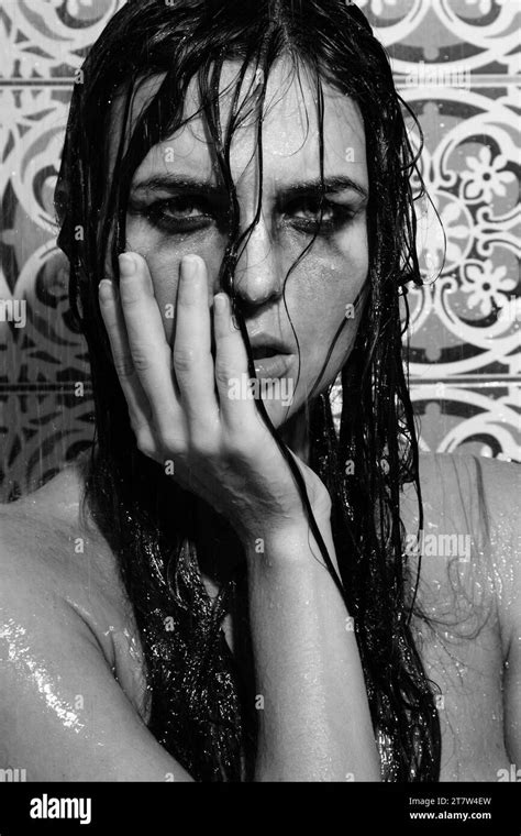 Sad And Wet Woman With Smudged Makeup On Her Face Under The Shower