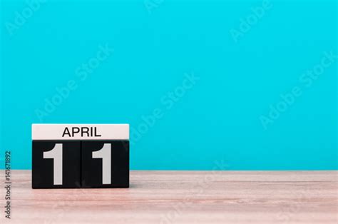 April 11th Day 11 Of Month Calendar On Wooden Table And Turquoise