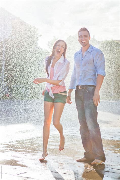 Couple Laughing In The Rain By Stocksy Contributor Lumina Stocksy