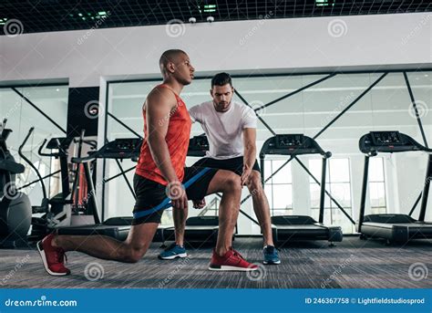 Attentive Trainer Controlling African American Sportsman Stock Photo