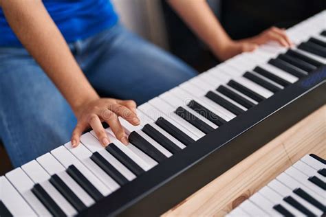 Young Chinese Woman Musician Playing Piano Keyboard At Music Studio