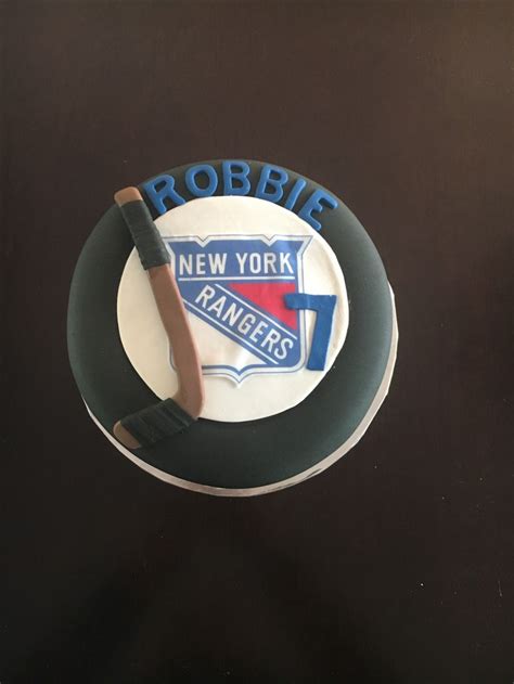 A New York Rangers Cake With The Name Robbie On It And A Baseball Bat