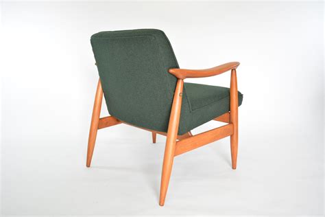 Wooden armchair built from instrument grade, curly acacia koa, for dining tables, boardroom tables, or occasional chairs in a matching set. Vintage green fabric and wood armchair - Design Market