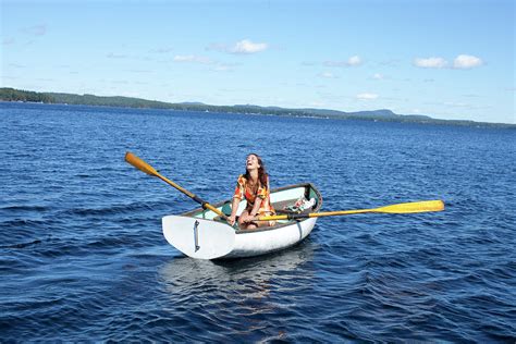 A Woman In A Small Rowboat On A Lake Photograph By Woods Wheatcroft