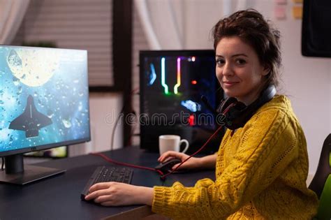 Portrait Of Focused Woman Gamer Looking Into Camera While Playing Space