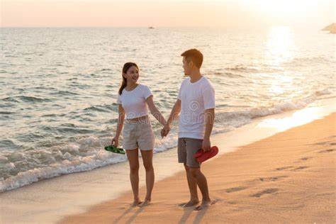 Vacation Loving Couple Walking On Beach Together At Sunset Landscape
