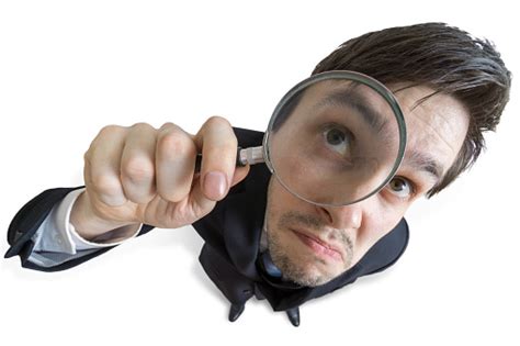 Young Businessman Is Looking Through Magnifying Glass Isolated On White