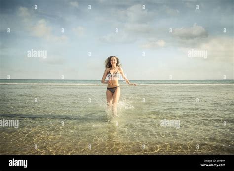 Woman In Bikini Running In The Water Stock Photo Alamy