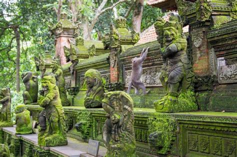 Monkey Climbs Statues At Sacred Monkey Forest Ubud Indonesia Ubud