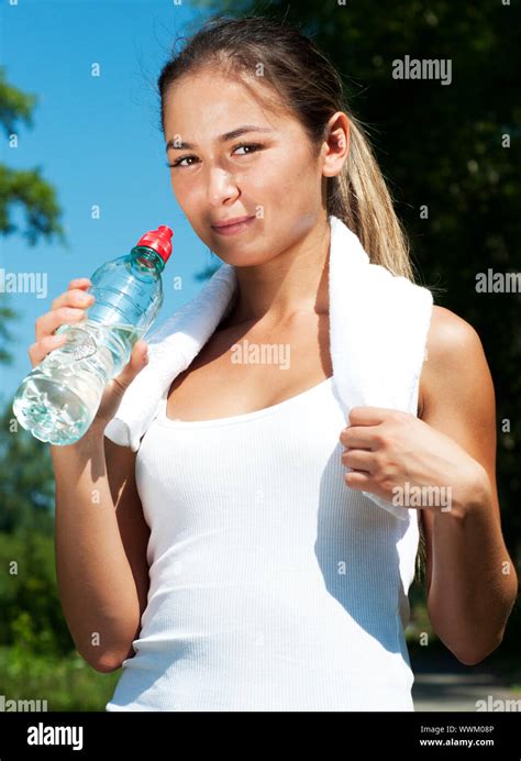 Young Woman Drinking Water After Exercise Summer Park Background Stock