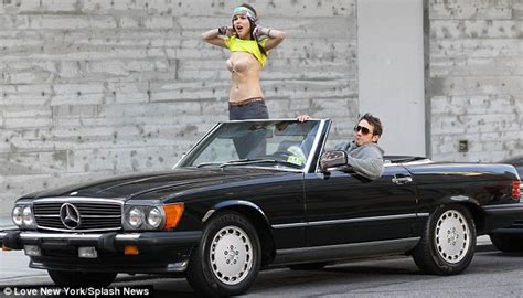 Leticia Peres Flashes Her Bra Atop A Convertible Mercedes While Filming