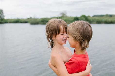 Fraternal Twins Hugging At The Beach Stock Image Image