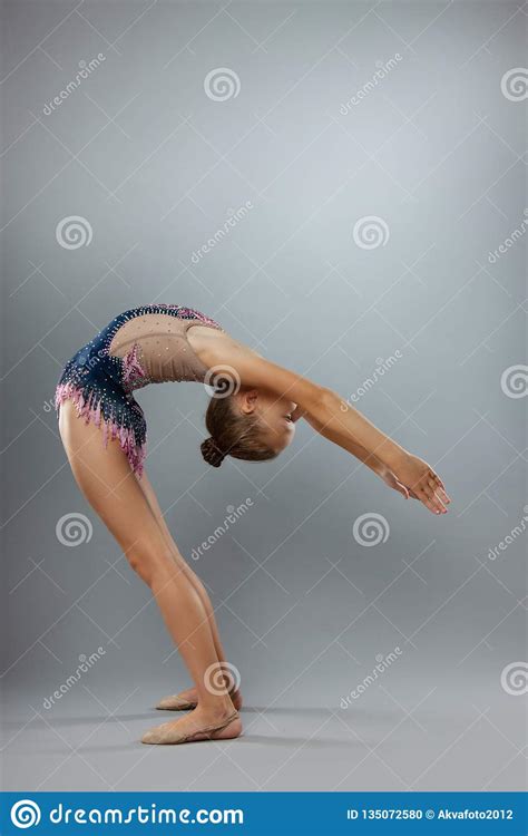 Beautiful Flexible Gymnast In Sports Outfit Performs An Element Of ...