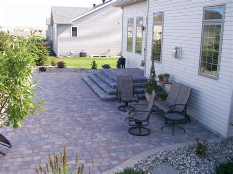 Multi Colored Paver Patio With Stair System And Rock Fill Edging