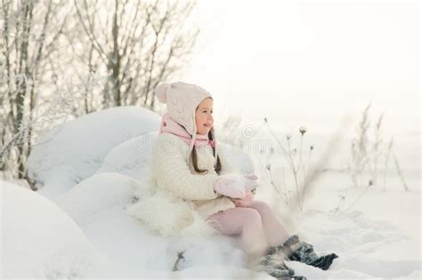 Happy Little Girl Plays In A Beautiful Snowy Winter Forest Stock Photo