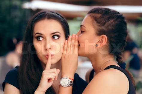 Indiscrete Gossiping Girl Telling Secrets To Her Surprised Friend Stock Image Colourbox