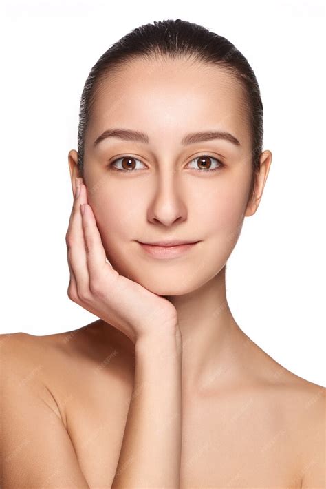free photo portrait of beautiful girl stroking her face with healthy skin