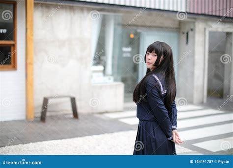 Portrait Japanese School Girl In Downtown At Ice Cream Shop Stock Image