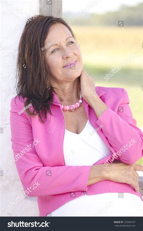 Portrait Sexy Confident And Happy Relaxed Mature Woman Posing Outdoor In Pink Jacket Smiling
