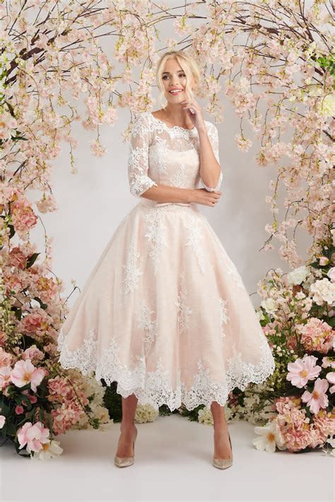 Elegant blush ballerina length wedding dress with three quarter sleeves