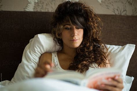 Woman Reading A Book In Bed By Stocksy Contributor Mosuno Stocksy