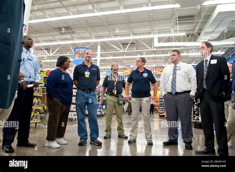 Group Of Multi Ethnic Wal Mart Employees And Managers During Informal