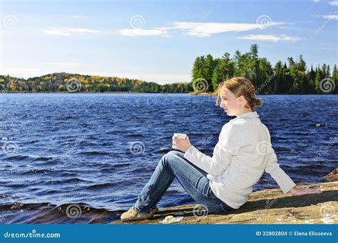 Young Woman Relaxing At Lake Shore Stock Photo Image Of Holding