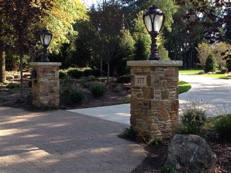 Stone Pillars And Landscaping For A Stunning Driveway Entrance