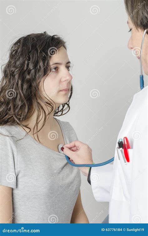 Doctor Female Auscultating Young Patient By Stethoscope Stock Photo
