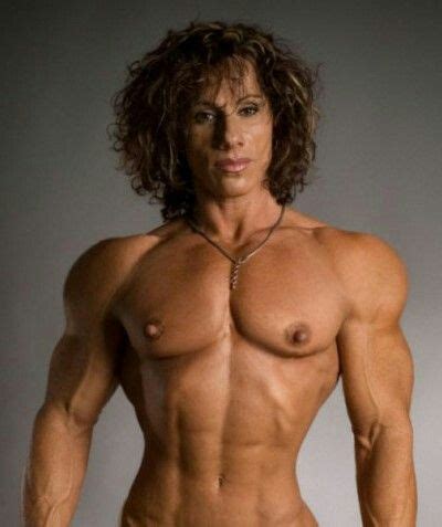 A Man With Long Hair And No Shirt On Posing For The Camera Showing Off His Muscular Body