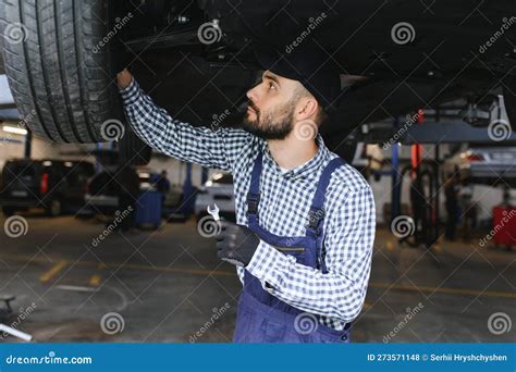 Auto Mechanic Working Underneath A Lifted Car Stock Photo Image Of