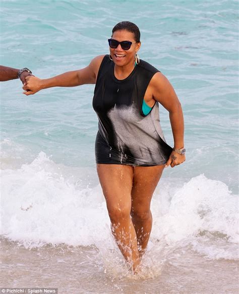 Queen Latifah Holds Hands With A Male Friend As They Drink Champagne And Frolic On The Beach In