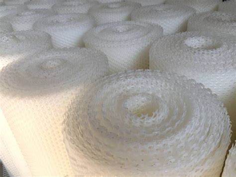 Several Rolls Of White Plastic Mesh Neatly Placed Together Plastic