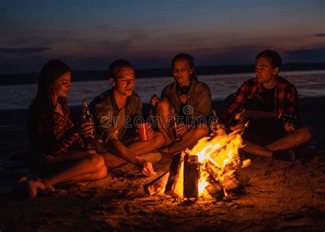 Young Friends Have Picnic With Bonfire On The Beach Stock Photo Image