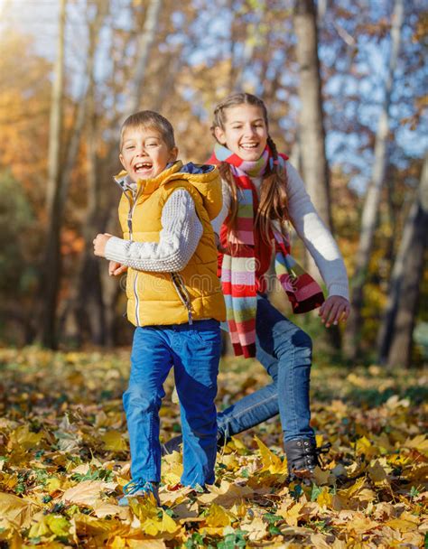 Kids Having Fun In Autumn Park Stock Photo Image Of Cheerful Park