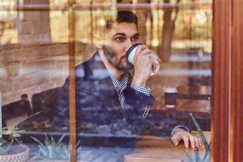 A Handsome Young Stylish Man Drinking Coffee In The Cafe Stock Photo