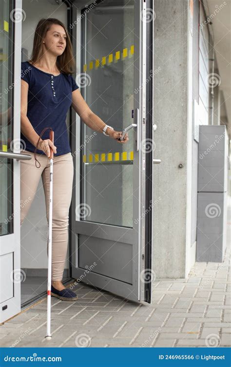 Blind Woman Walking On City Streets Using Her White Cane Stock Photo