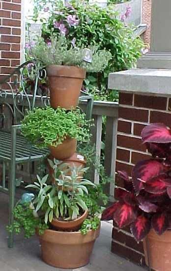 Several Potted Plants Sitting On Top Of Each Other In Front Of A Brick
